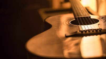 acoustic guitar close-up on a beautiful colored background