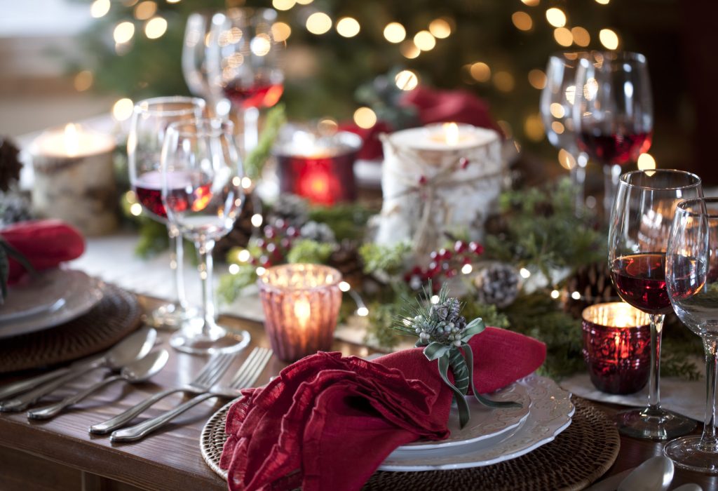 Christmas holiday dining table elegant place setting. Very shallow depth and dramatic lighting
